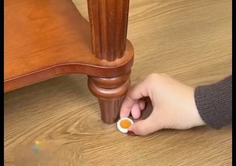 Applying cockroach killer gel near furniture to effectively eliminate pests