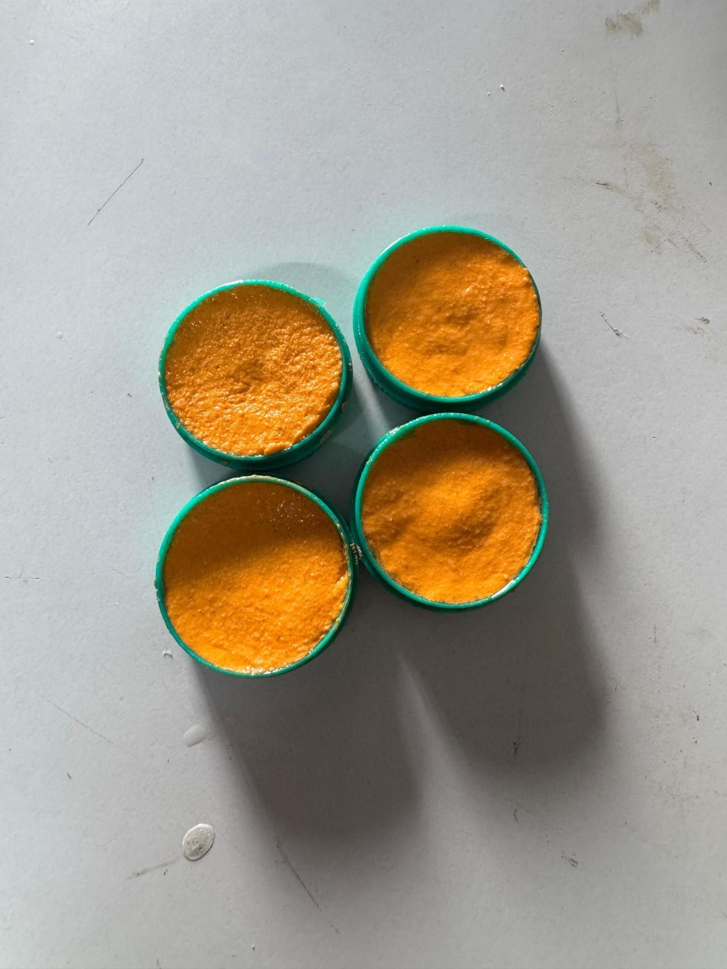 Four containers of cockroach killer gel in bright orange color for effective pest control
