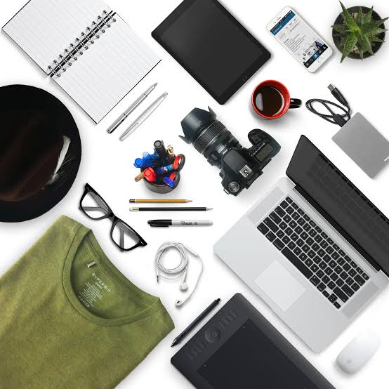 Flat lay of workspace items including laptop, tablet, camera, and notes for smart home gadgets online