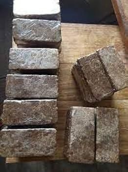 Pack of black dishwashing soap bars arranged neatly on a wooden surface