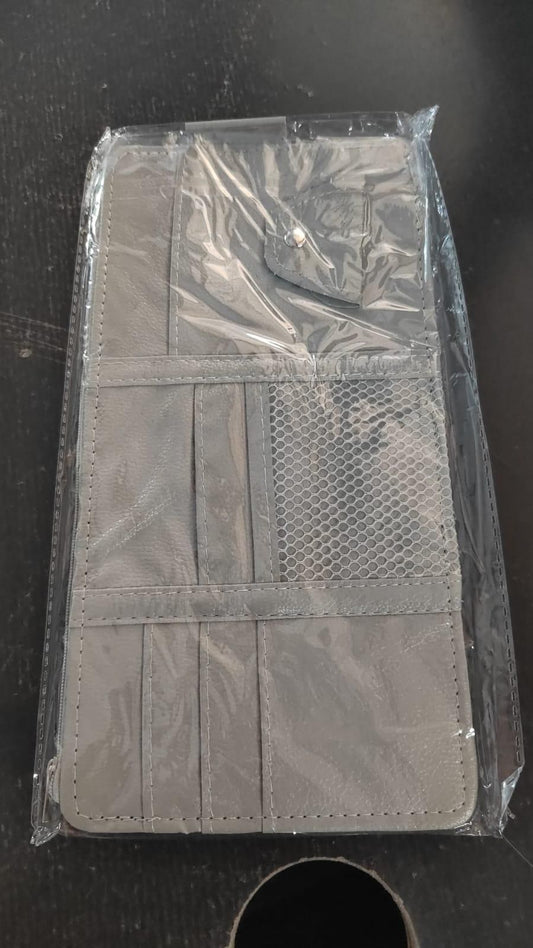 Gray car visor organizer with multiple pockets and mesh sections for easy access to essentials