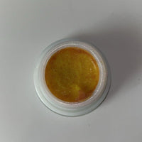 Cockroach killer gel in a white container with a yellow gel product visible inside