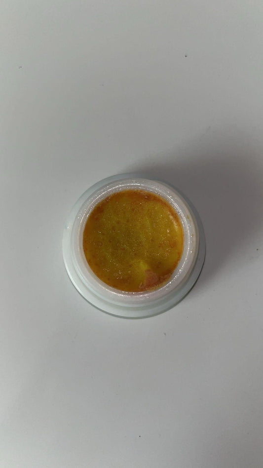 Cockroach killer gel in a white container with a yellow gel product visible inside