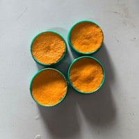 Four containers of cockroach killer gel in bright orange color for effective pest control