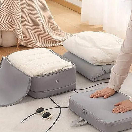 Gray compression storage bags for travel holding blankets and clothes, saving space for easy packing