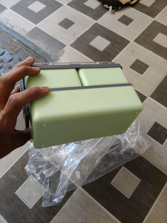 Eco-friendly lunch container in green with secure closure for storing meals on the go