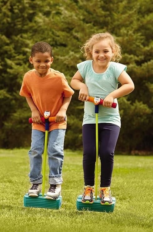 Two kids happily jumping on foam pogo jumper for kids in a lush green park