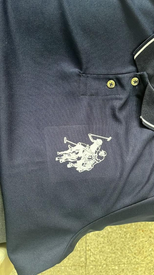 Close-up of a navy blue men's polo t-shirt pack featuring a classic logo design