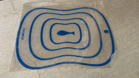 Transparent flexible cutting board with blue outlines and fish design for easy food preparation