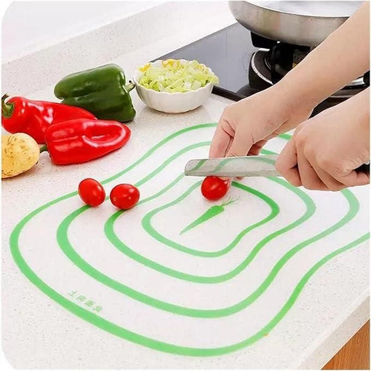 Transparent flexible cutting board used for chopping vegetables and food preparation on a clean kitchen surface