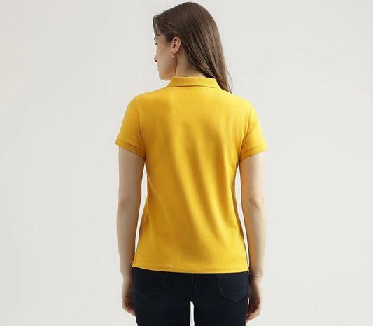 Back view of a woman wearing a yellow cotton polo shirt, featuring a classic collar and short sleeves